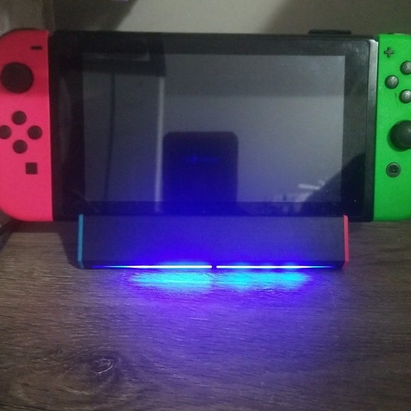 Nintendo Switch with Neon Red and Neon Green Joy‑Cons.